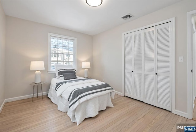 bedroom with a closet and light wood-type flooring