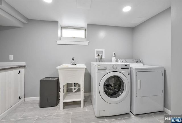 clothes washing area with washer and dryer