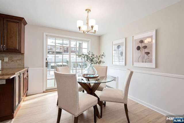 dining space with an inviting chandelier and light wood-type flooring