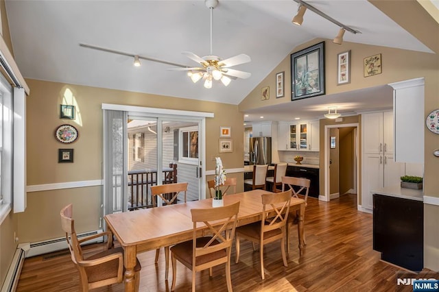 dining area featuring hardwood / wood-style flooring, vaulted ceiling, a wealth of natural light, and baseboard heating