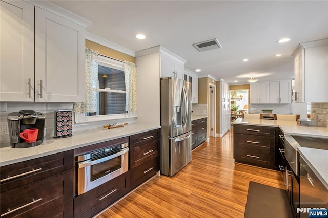 kitchen featuring stainless steel appliances and white cabinets