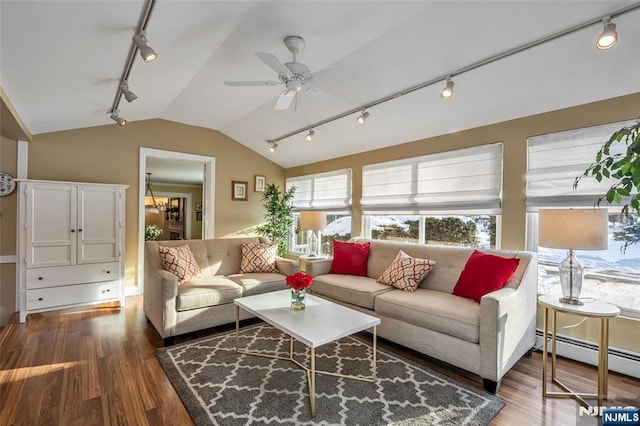 living room with ceiling fan with notable chandelier, wood-type flooring, a baseboard radiator, and vaulted ceiling