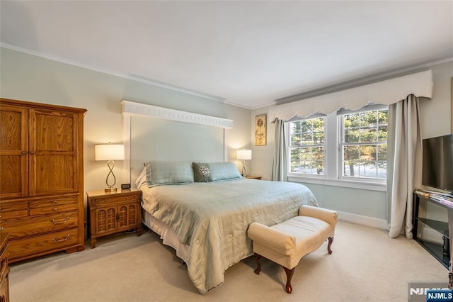 bedroom featuring ornamental molding and light colored carpet