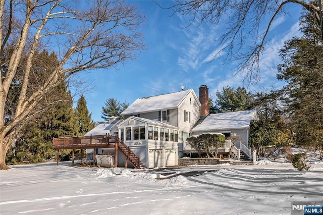 exterior space with a sunroom and a deck