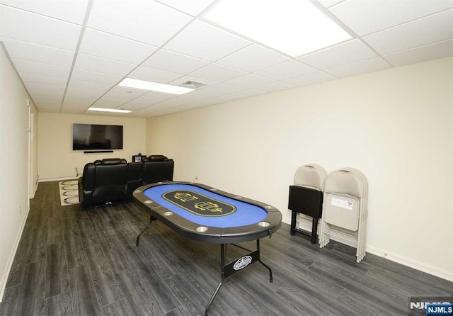 playroom with dark hardwood / wood-style flooring and a drop ceiling