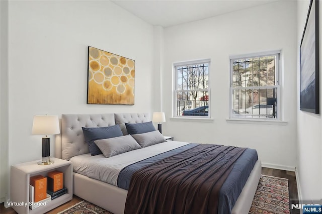 bedroom with wood finished floors