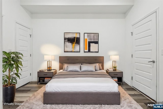 bedroom featuring wood finished floors and baseboards