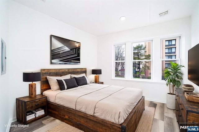 bedroom featuring recessed lighting, wood finished floors, visible vents, and baseboards