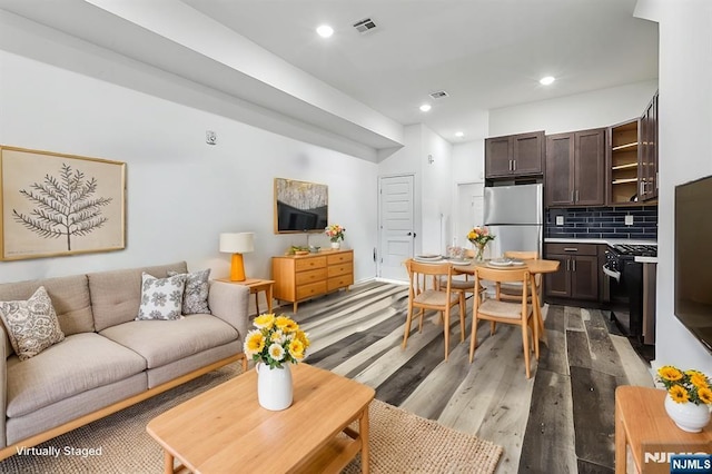 living room featuring recessed lighting, visible vents, and light wood-style floors