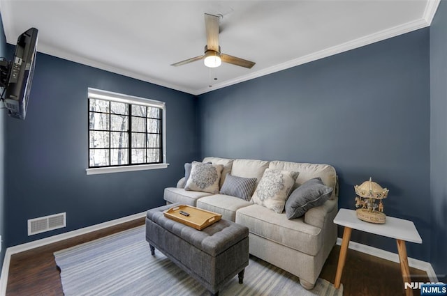 living room with ceiling fan, wood-type flooring, and ornamental molding