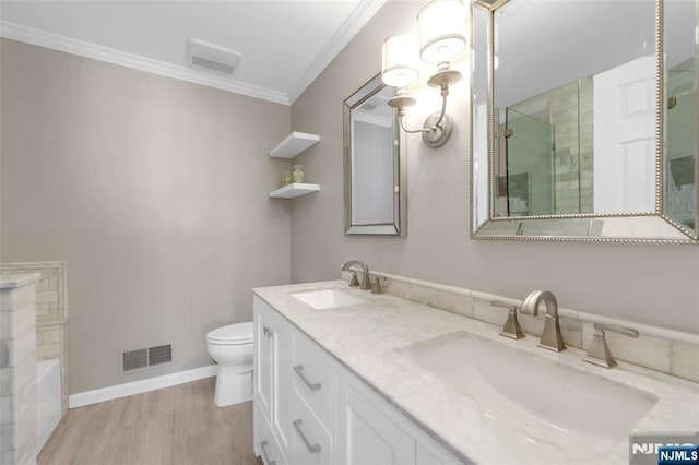 full bathroom featuring separate shower and tub, vanity, wood-type flooring, ornamental molding, and toilet