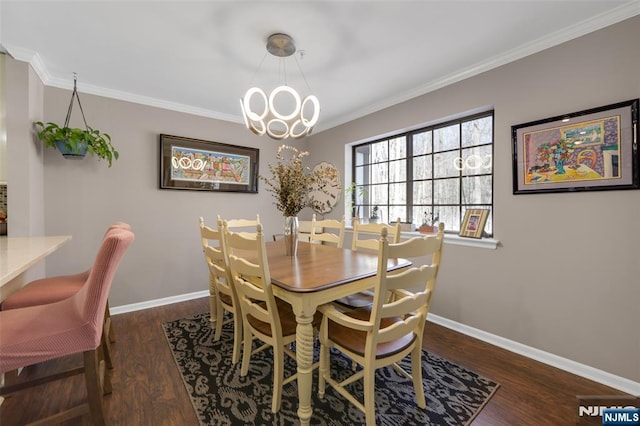 dining room with crown molding, dark wood-type flooring, and a chandelier