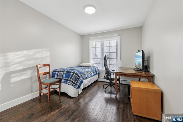 bedroom with dark wood-type flooring