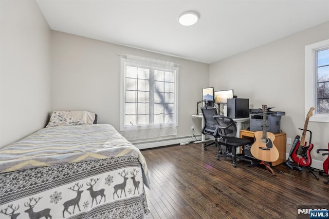 bedroom featuring dark hardwood / wood-style flooring and a baseboard heating unit