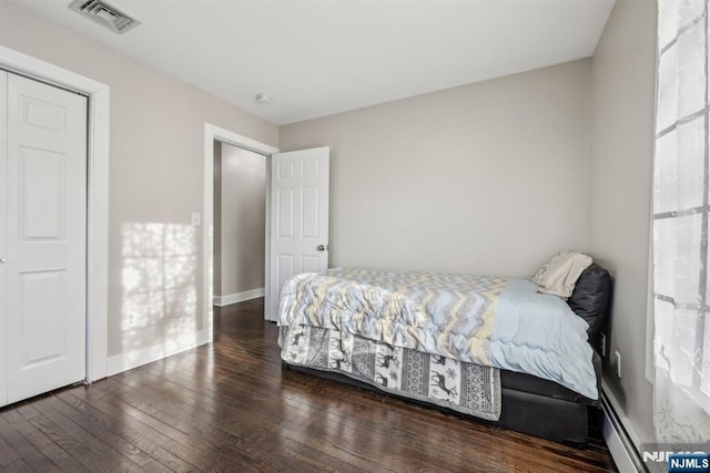 bedroom with dark hardwood / wood-style floors