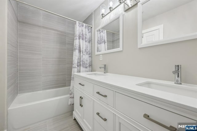 bathroom featuring vanity and shower / bathtub combination with curtain