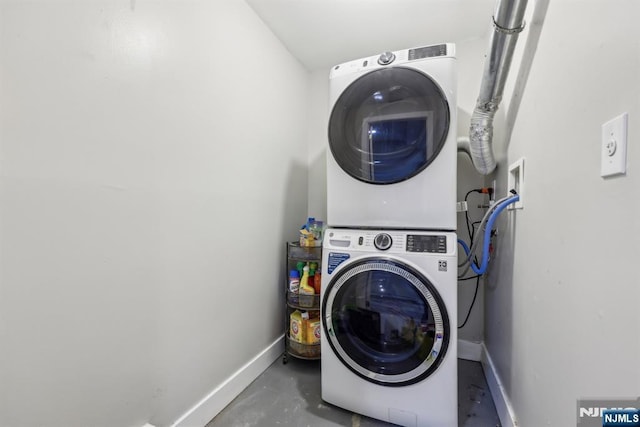 clothes washing area featuring stacked washer / dryer