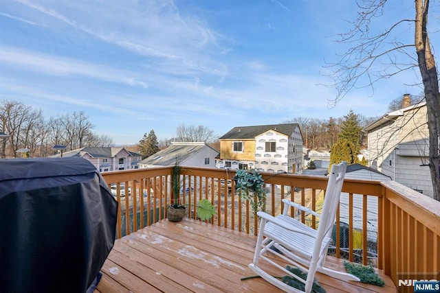 wooden terrace featuring area for grilling