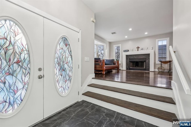 entrance foyer featuring a premium fireplace