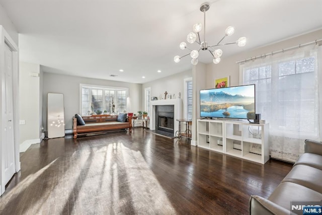 living room with dark hardwood / wood-style flooring and a notable chandelier