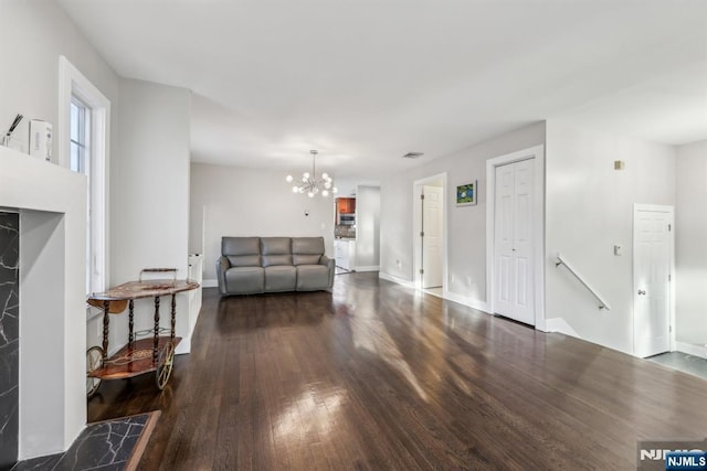 living room featuring dark hardwood / wood-style floors and a chandelier