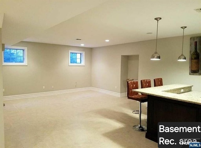 interior space with visible vents, baseboards, light colored carpet, decorative light fixtures, and recessed lighting