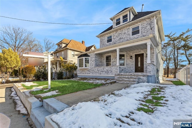 view of front facade featuring a yard and covered porch