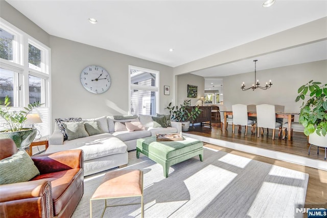 living room with a chandelier and light wood-type flooring