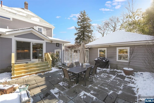 snow covered patio featuring grilling area