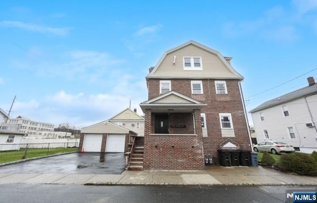 23 Roma St, Nutley, NJ 07110 - dutch colonial with brick siding, a gambrel roof, fence, and a detached garage