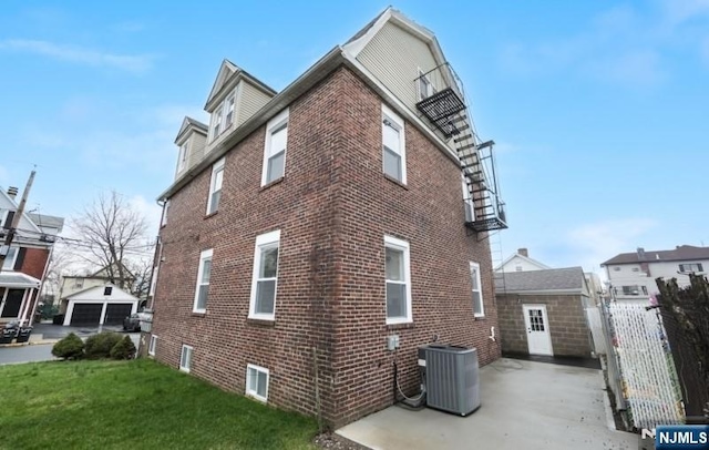 23 Roma St, Nutley, NJ 07110 - view of home's exterior featuring cooling unit, a lawn, fence, and brick siding