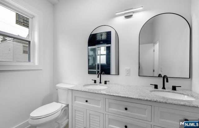 23 Roma St, Nutley, NJ 07110 - full bath with double vanity, baseboards, a sink, and toilet