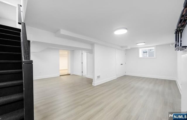 23 Roma St, Nutley, NJ 07110 - basement featuring baseboards, stairway, and light wood finished floors