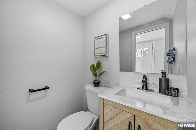 bathroom featuring vanity and toilet