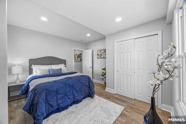 bedroom with hardwood / wood-style flooring and a closet