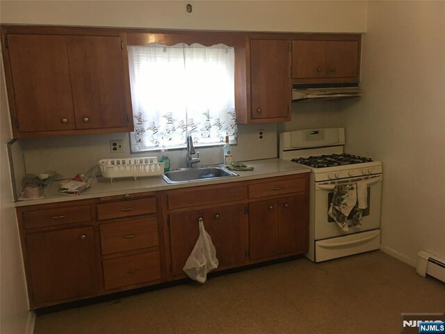 kitchen with a baseboard heating unit, white range with gas cooktop, and sink