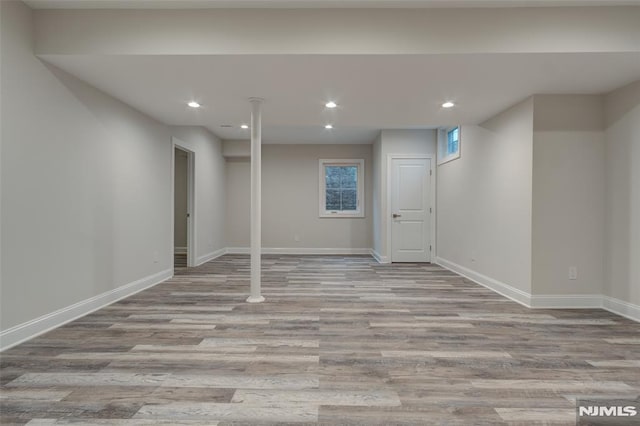 basement with light hardwood / wood-style flooring