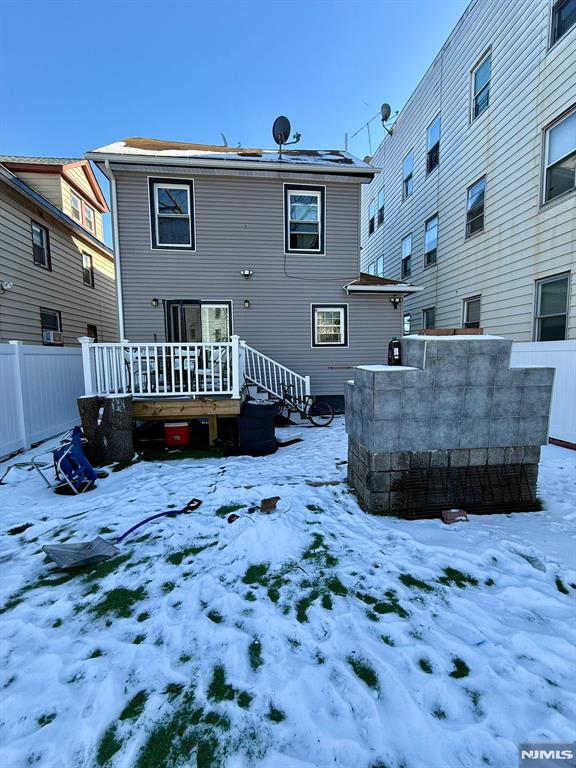 view of snow covered rear of property