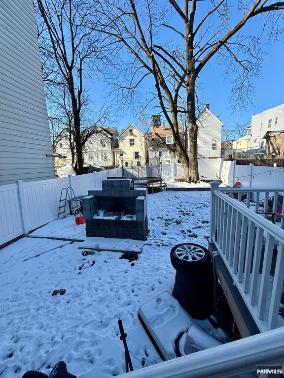 snowy yard with a trampoline