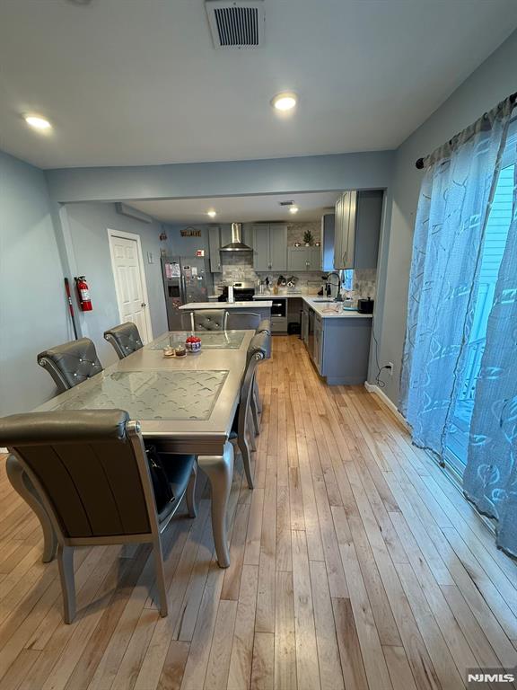 dining area featuring sink and light hardwood / wood-style flooring