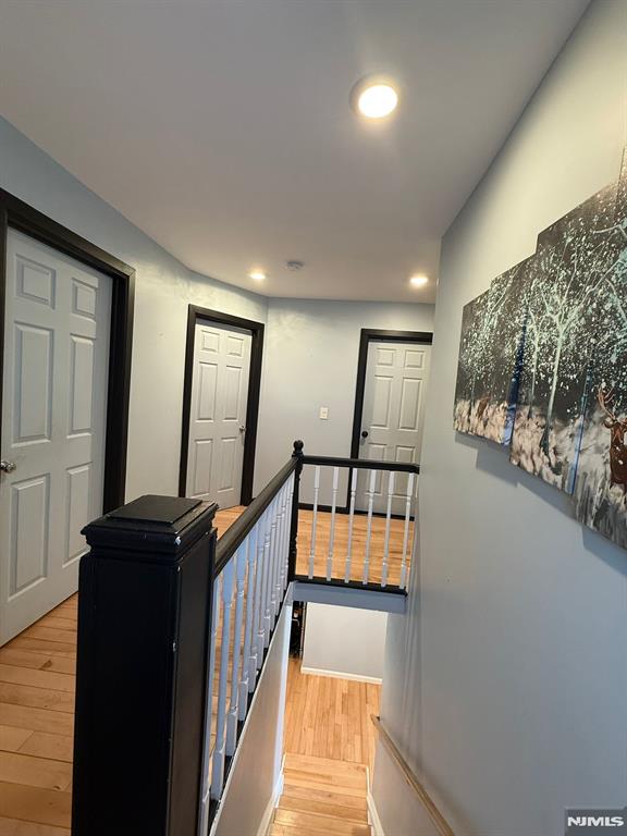 hallway with hardwood / wood-style floors