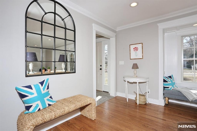 foyer entrance featuring hardwood / wood-style flooring and crown molding