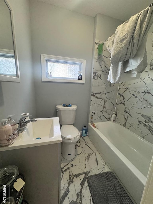 full bathroom featuring vanity, toilet, and tiled shower / bath combo