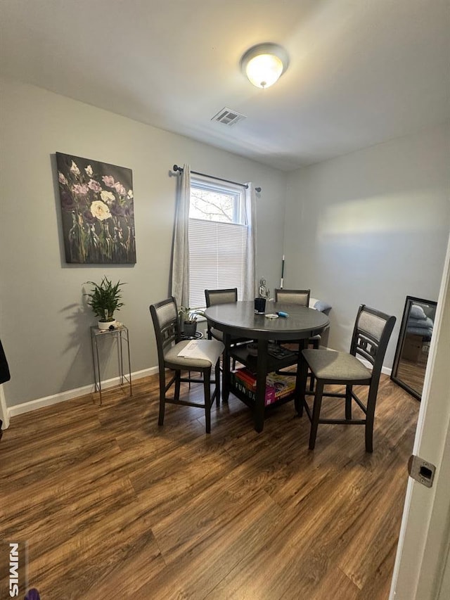 dining space featuring dark hardwood / wood-style flooring