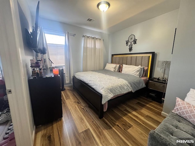 bedroom with hardwood / wood-style flooring