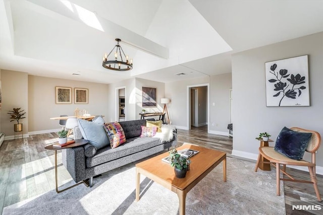 living room featuring a notable chandelier and wood-type flooring