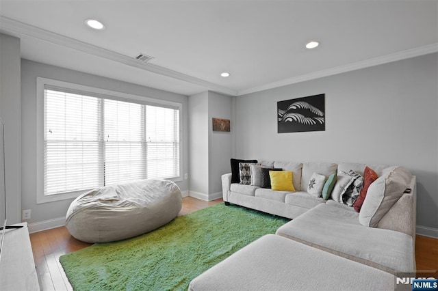 living room featuring hardwood / wood-style flooring and ornamental molding