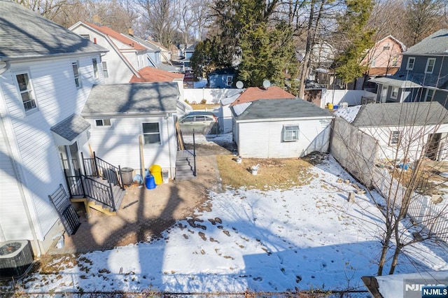 snowy aerial view featuring a residential view