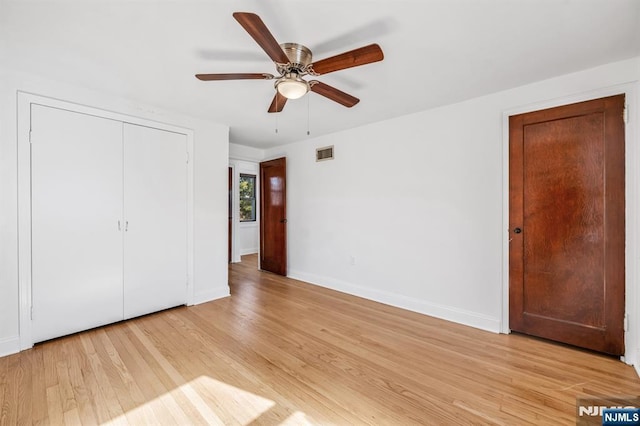 unfurnished bedroom with ceiling fan, light hardwood / wood-style floors, and a closet