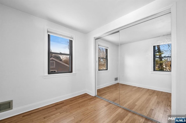 spare room with hardwood / wood-style floors and a wealth of natural light